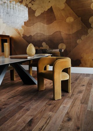 A modern dining room with a retro 70s brown theme and wooden flooring
