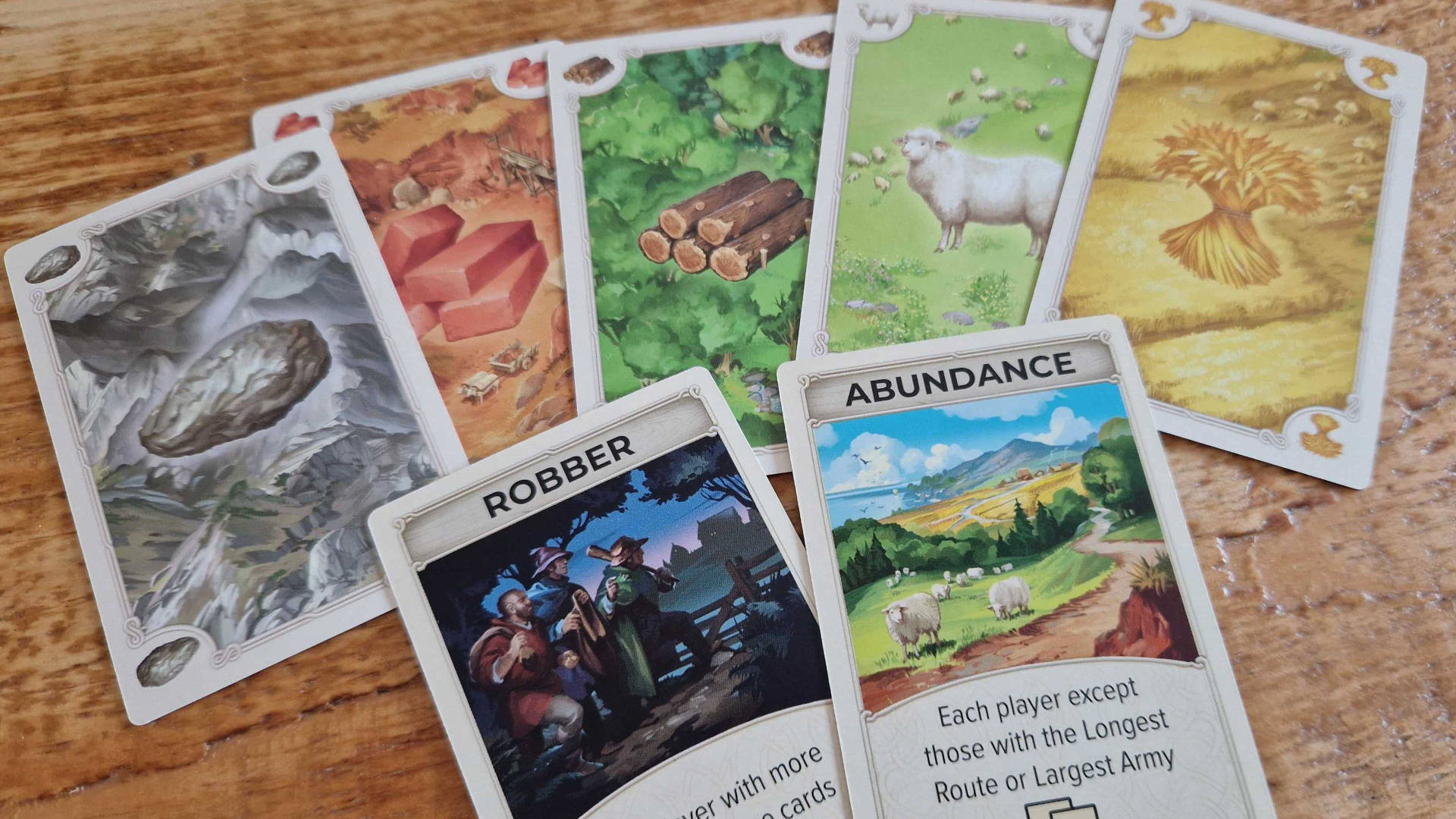 Catan on the Road cards on a wooden table