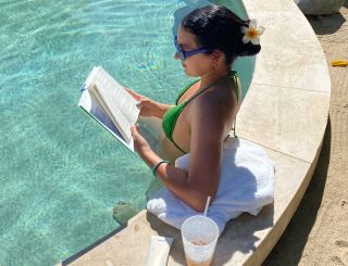Woman in pool reading