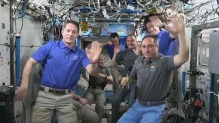 The astronauts of Expedition 66 on the International Space Station wave after a change of command ceremony handed control of the station from ESA astronaut Thomas Pesquet (left) to Russian cosmonaut Anton Shkaplerov on Nov. 6, 2021 ahead of SpaceX's Crew-2 Dragon departure.