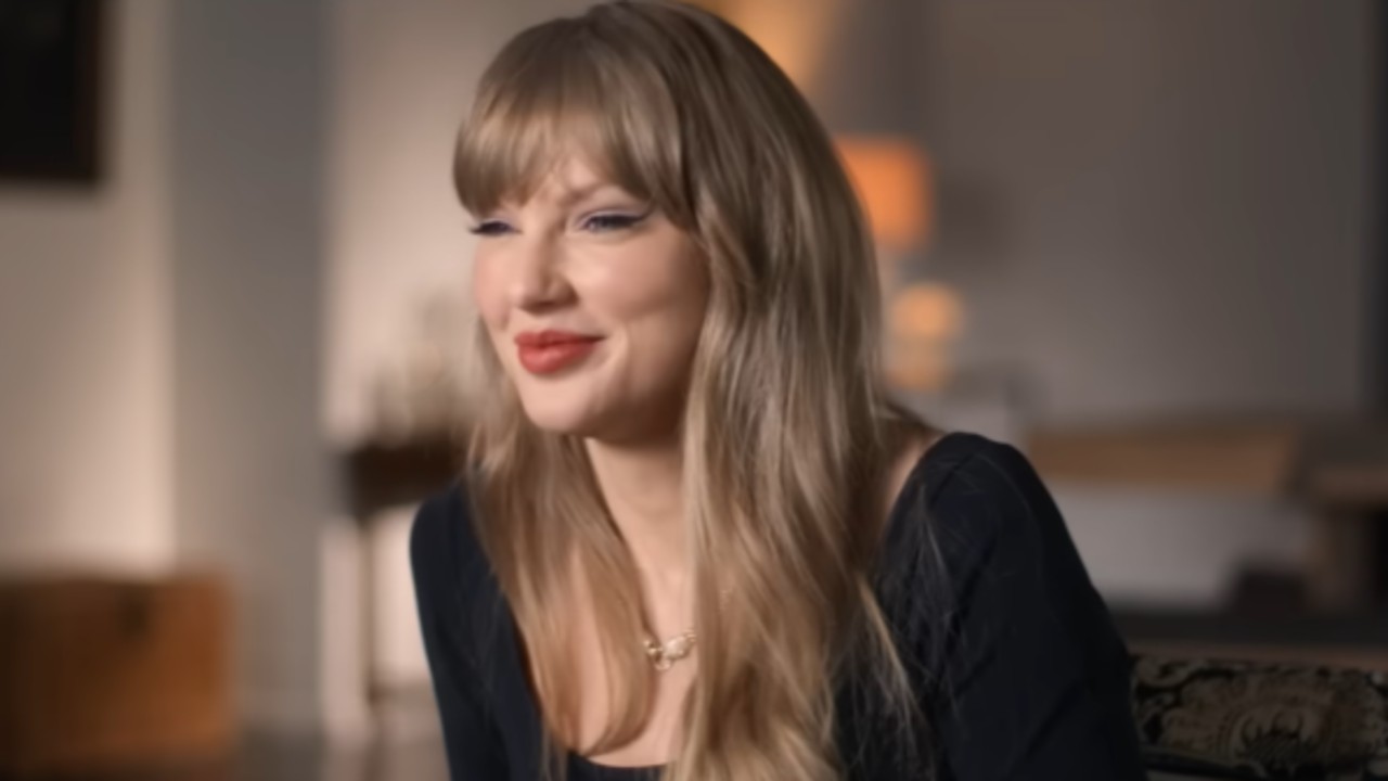 Taylor Swift smiling in The End of an Era trailer. 