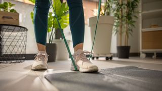 Close-up of foot stepping on resistance band