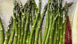 Asparagus baking on metal baking tray