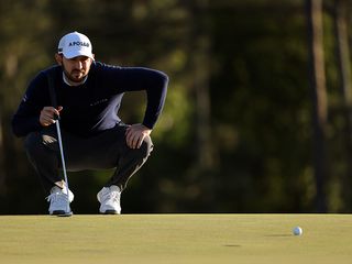 Patrick Cantlay reading the green before a putt