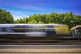Image of a train moving at speed through a station