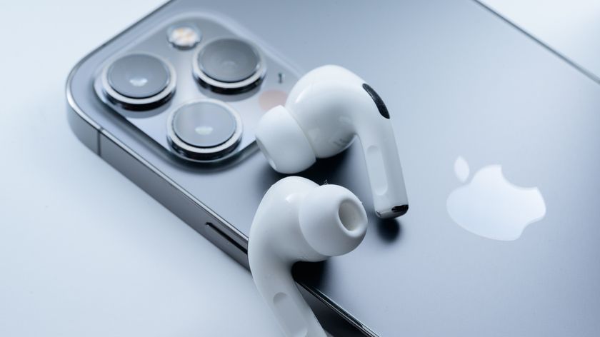 Apple AirPods Pro 2 on top of iPhone on gray background