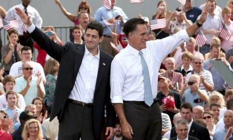 Mitt Romney and Rep. Paul Ryan (R-Wis.) wave as Ryan is announced as Romney&amp;#039;s vice presidential running mate in front of the U.S.S. Wisconsin on Aug. 11 in Norfolk, Va. Ryan, a seven term con