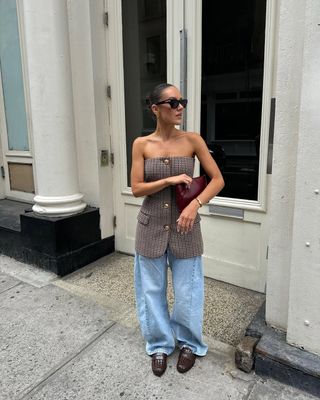 woman wearing baggy jeans and strapless blazer top