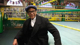 Jay Blades sitting on the rim of a boxing ring in Jay Blades: East End Through Time