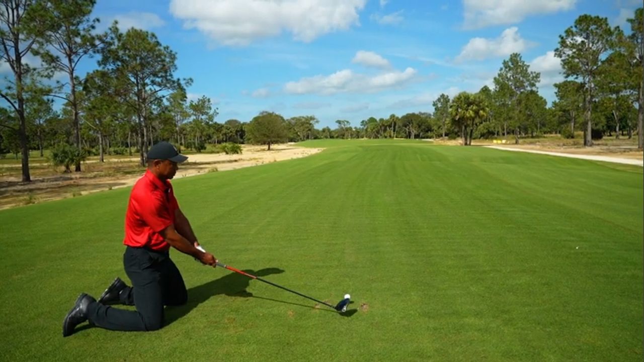 Tiger Woods takes a shot off his knees