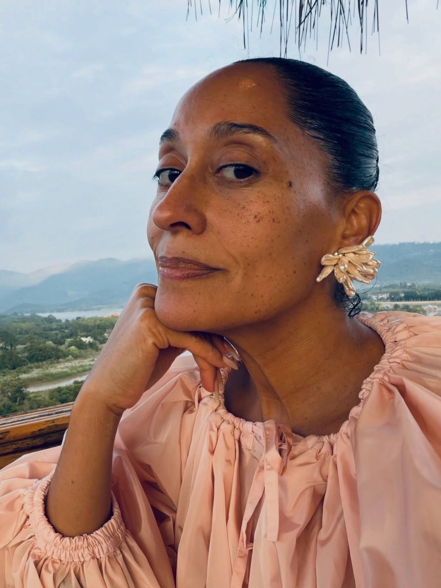 @traceellisross wearing a pink dress, with glowing skin