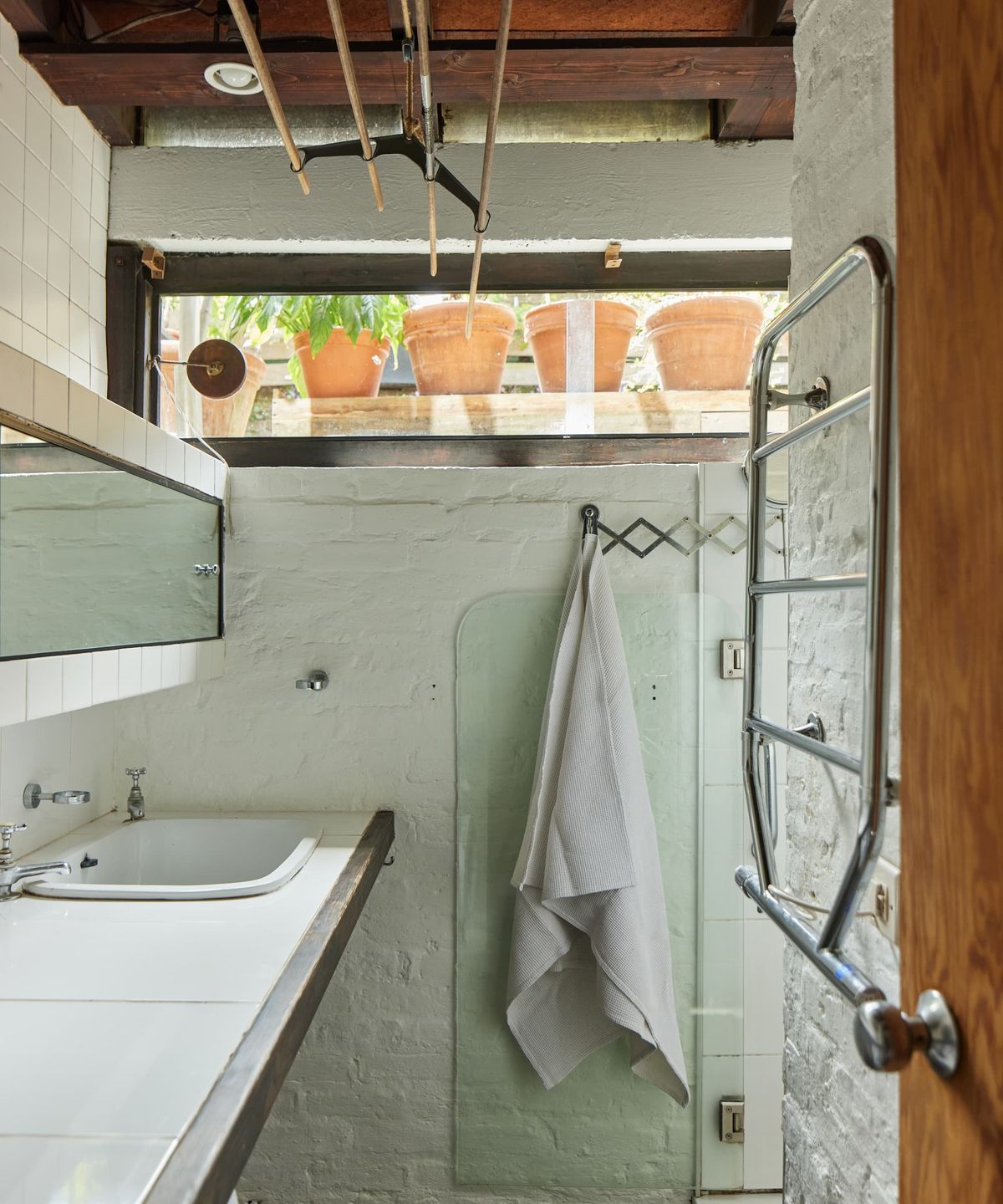 A bathroom with railings and a walk in shower