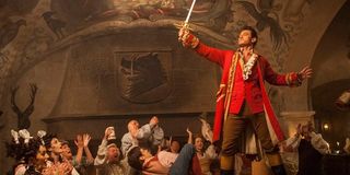 gaston raising sword in triumph in beauty and the beast