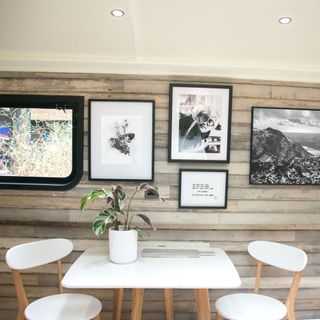 dining area with photo frames and table and chair