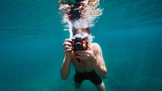 person using a camera underwater