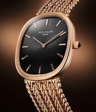 gold watch with intricate bracelet and black face