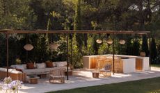 An outdoor kitchen and seating area covered with wooden beams