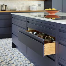 Blue kitchen with kitchen drawer containing pans