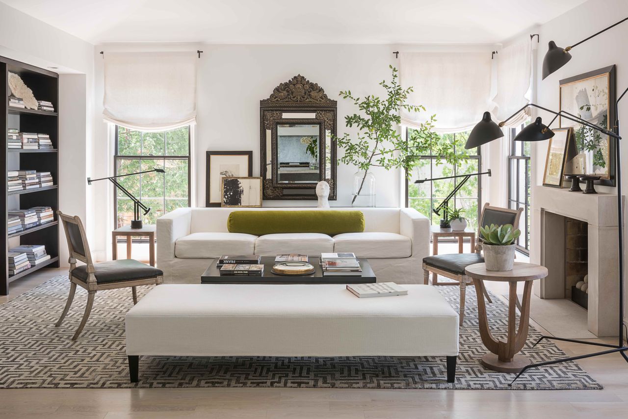 white living room with cream couches and an indoor tree