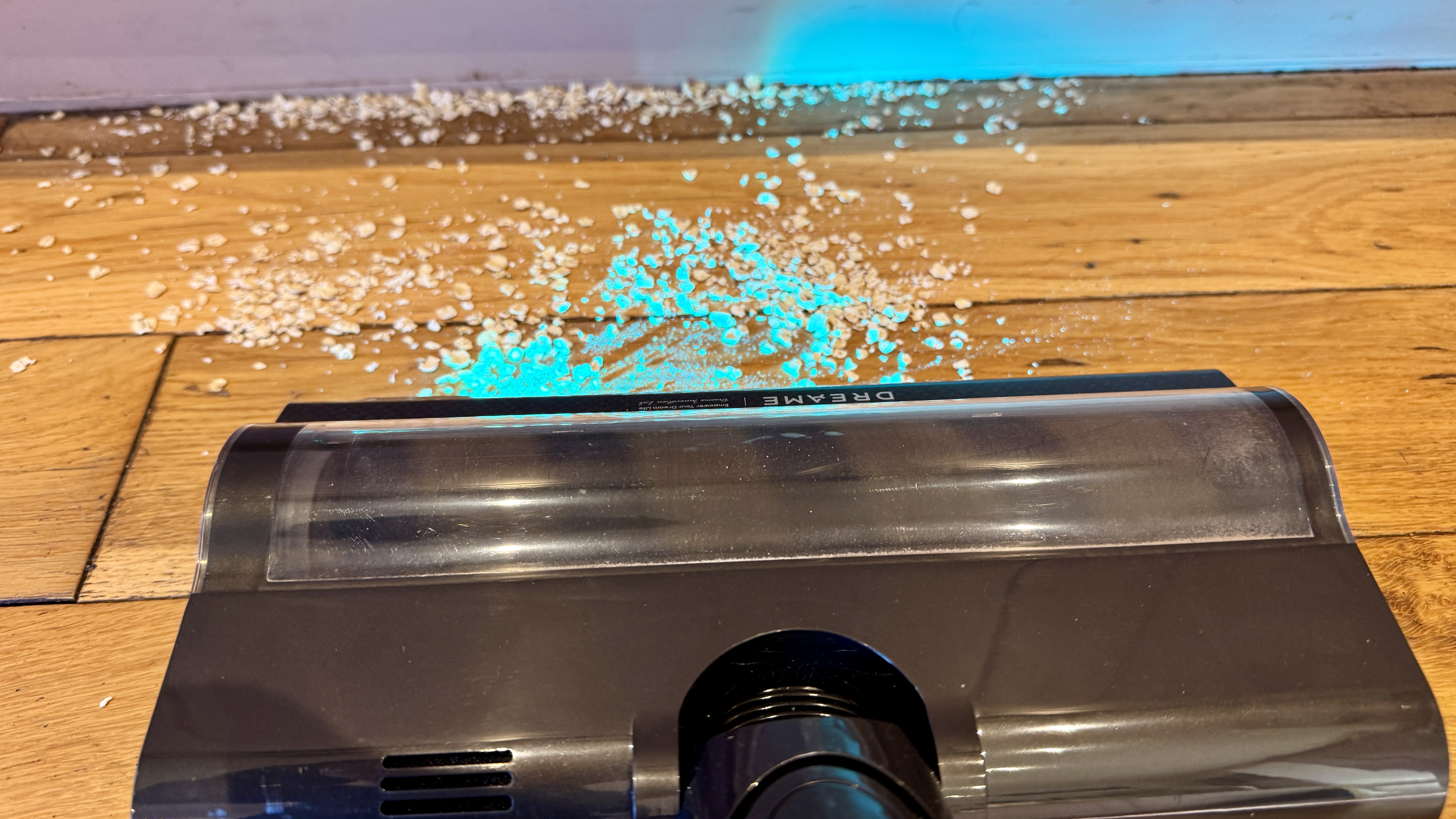 Debris on the edge of a room before cleaning with the Dreame V20 Pro vacuum