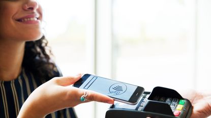 woman using mobile wallet at a checkout