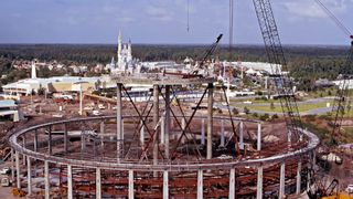 Construction beams form the outside of a circular structure that would become Space Mountain at Walt Disney World.