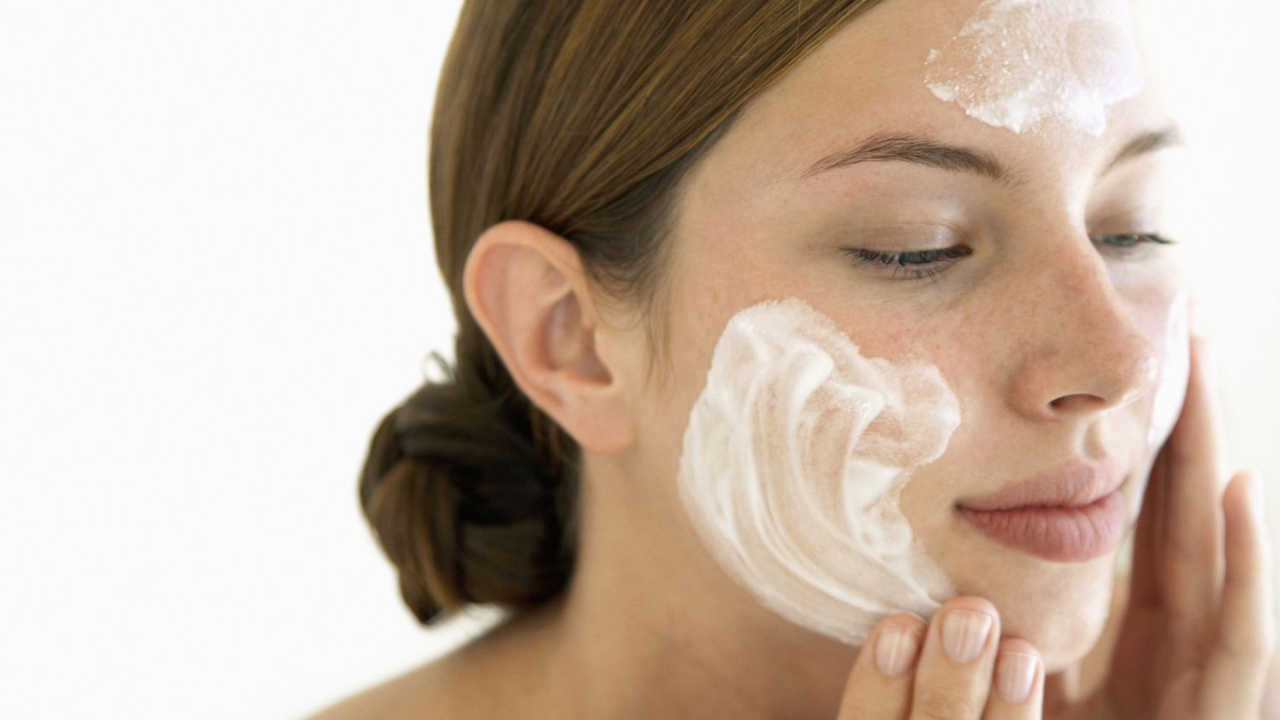 Woman applying sunscreen to her face