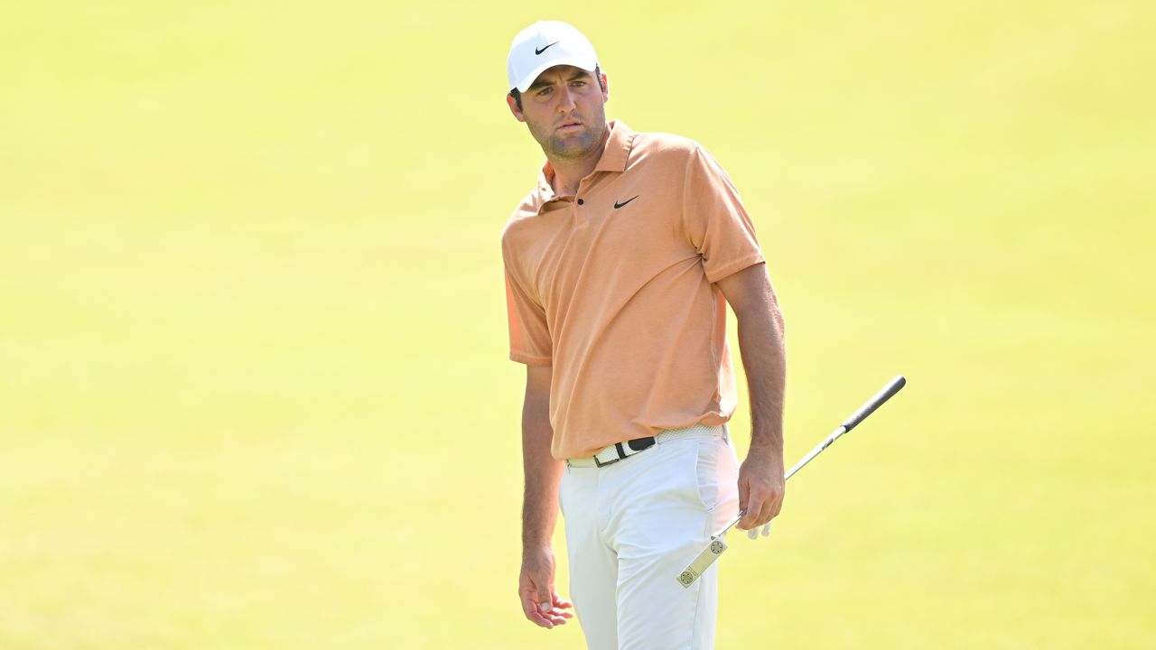 Scottie Scheffler looks on after hitting a putt