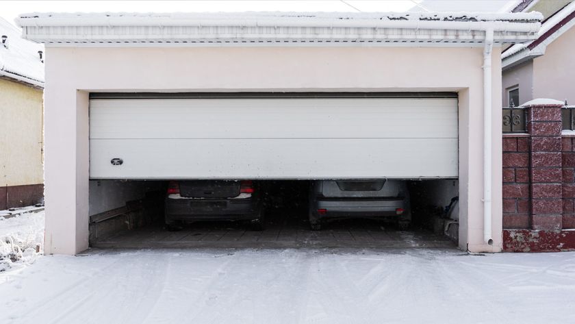 Garage door half open on snowy day 