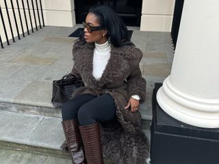 @nlmarilyn in a shearling coat and Bottega Veneta Andiamo bag.