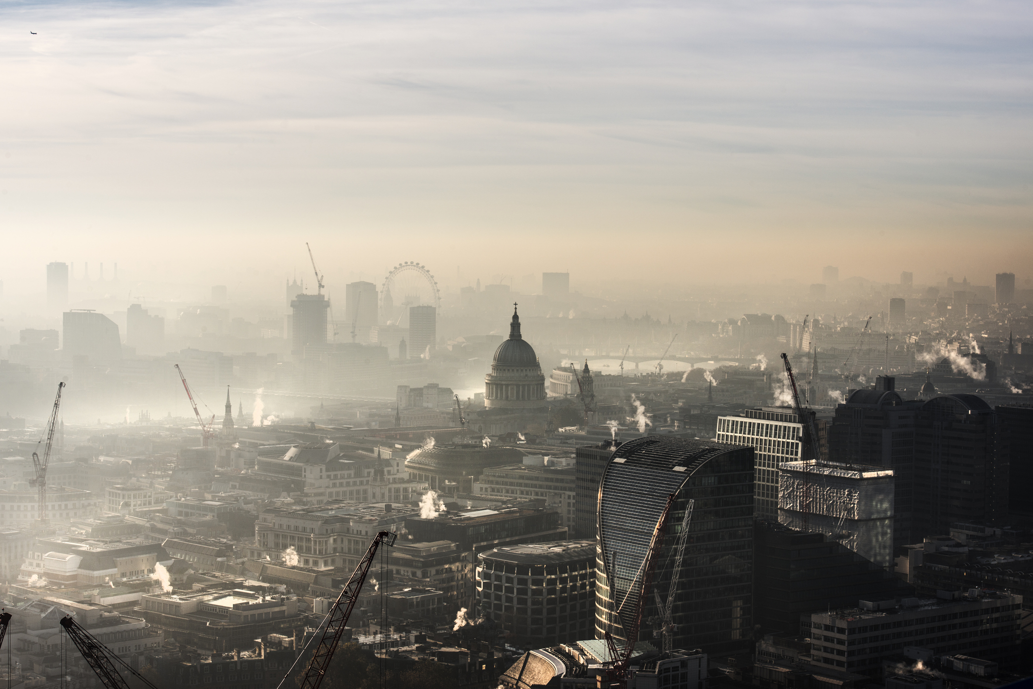 An aerial view of London, with a thick bank of mist covering iconic buildings such as St Paul's