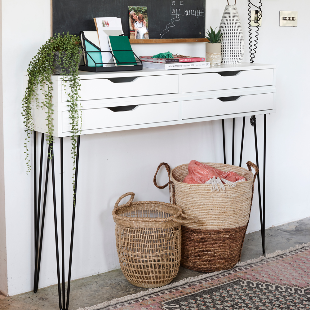 white room with baskets and white drawers