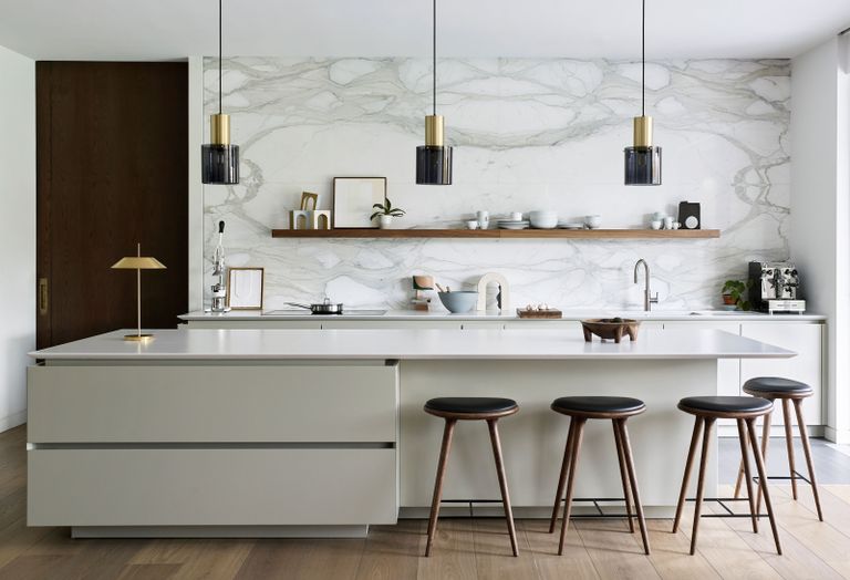 a modern minimal kitchen with three pendant lights