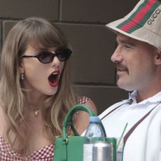 Taylor Swift looking surprised with Travis Kelce