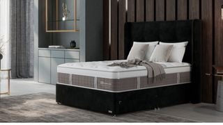 The image shows the Sealy Posturepedic Exquisite Platinum Mattress in a sleek and modern bedroom