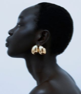 woman wearing gold hoop earrings