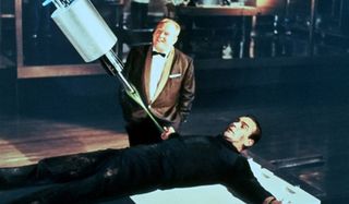 Goldfinger Gert Frobe threatens Sean Connery with a laser
