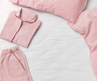 Pink pin striped PJs folded on a bed