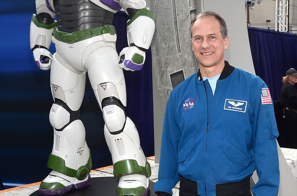 NASA astronaut Tom Marshburn poses beside a life-size statue of Buzz Lightyear at the world premiere of the feature film &quot;Lightyear&quot; at the El Capitan Theatre in Hollywood, California on June 8, 2022. 