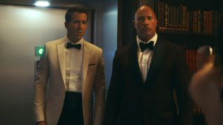 Dwayne Johnson and Ryan Reynolds in suits in Red Notice