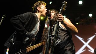 Jason Newsted (L) and Robert Trujillo of Metallica perform the finale at Day One of the bands' 30th Anniversary shows at The Fillmore on December 5, 2011 in San Francisco, California.
