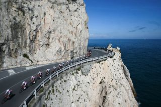 The pack rides along Capo Noli during the 115th Milan-SanRemo one-day classic cycling race, between Pavia and SanRemo, on March 16, 2024. (Photo by Marco BERTORELLO / AFP)