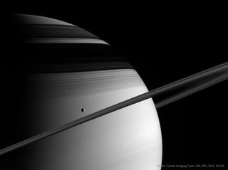 A view of Saturn and the moon Tethys, captured by the Cassini probe in 2005.