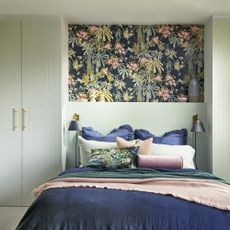 bedroom with wardrobe and pillows on bed