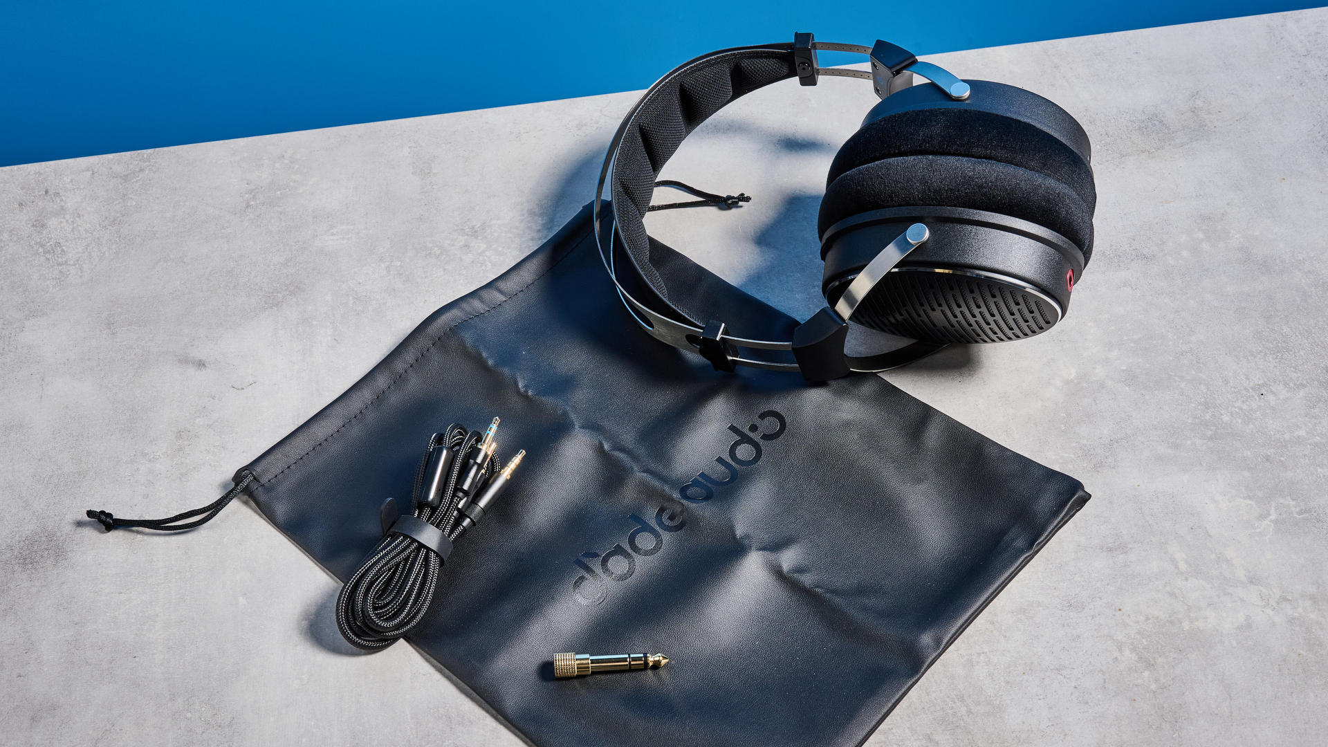 the FiiO JT3 headphones in black and silver shown against a blue tom's guide background