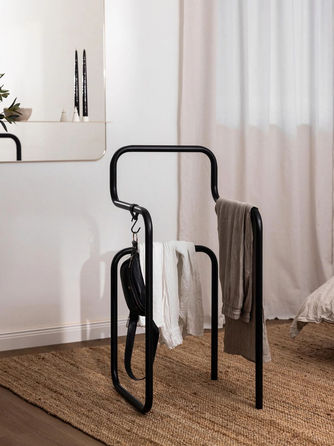 A black metal clothes rack and valet stand from Metallbude