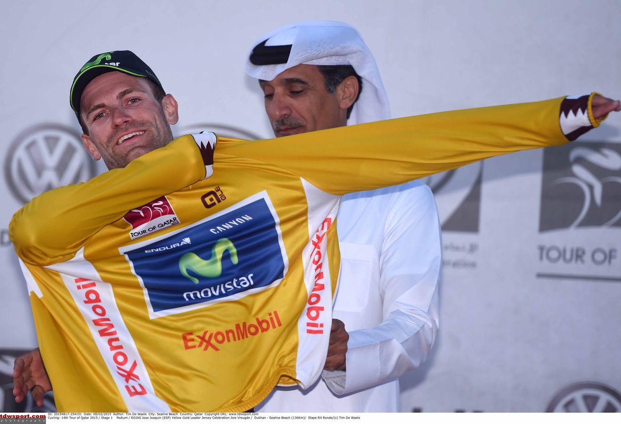 Jos&eacute; Joaquin Rojas is helped into the gold jersey.