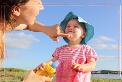 How to get sunscreen out of clothes as illustrated by a mother putting sun cream on toddler girl 