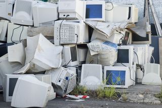 pile of computer monitors, e-waste
