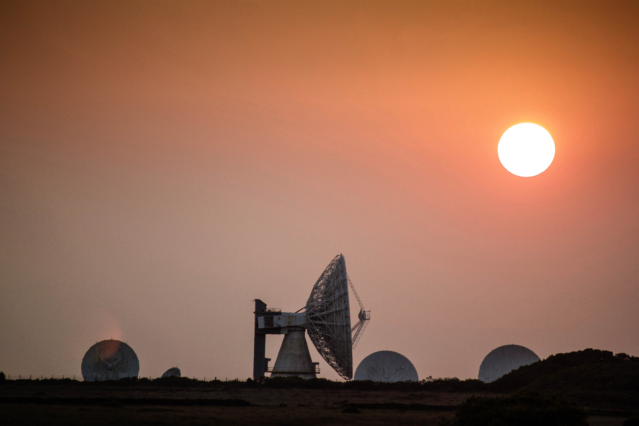 An antenna set against a sunset sky from Goonhilly Earth Station in Cornwall, U.K.